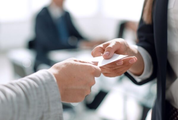 Two business people exchanging business cards